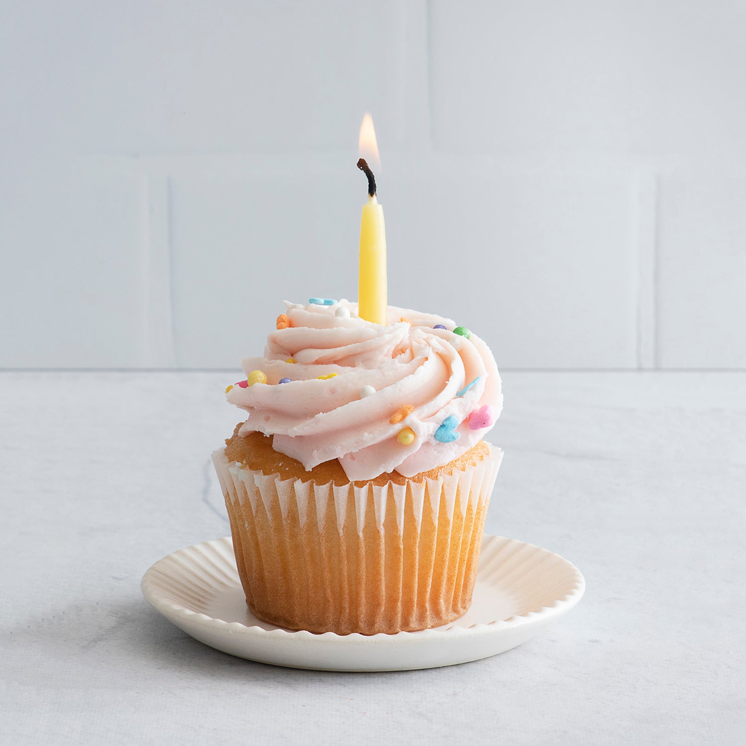 Non-toxic hand-dipped beeswax birthday candles in a box of 10, eco-friendly and made from pure beeswax; celebration theme, eco-friendliness, non-toxic nature, pure beeswax ingredients.