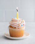 Non-toxic hand-dipped beeswax birthday candles in a box of 10, eco-friendly and made from pure beeswax; celebration theme, eco-friendliness, non-toxic nature, pure beeswax ingredients.