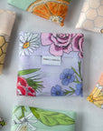 Reusable shopping tote bag with colorful flower patterns, eco-friendly, durable for shopping and farmers markets, sustainable and stylish.