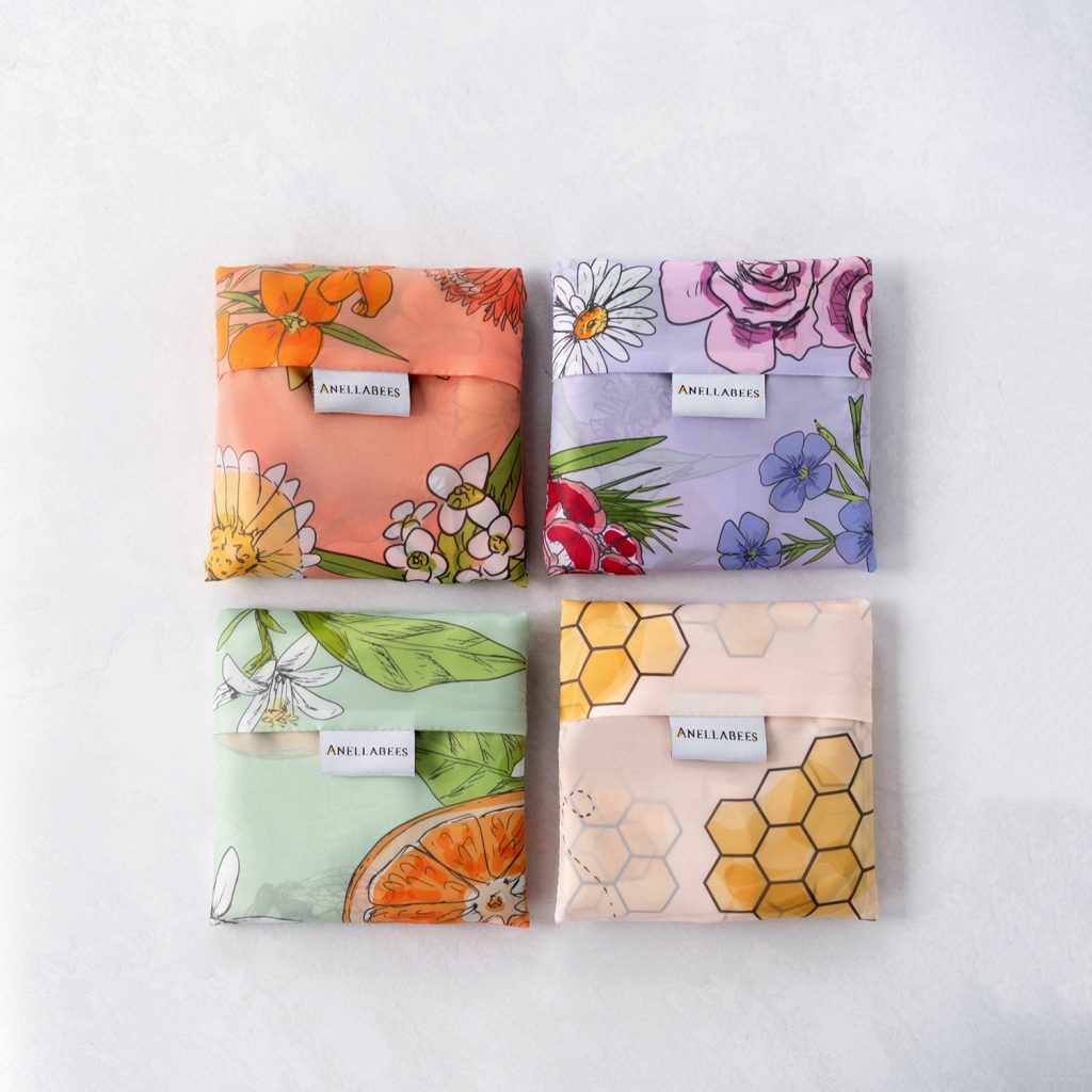 Reusable shopping tote bag with colorful flower patterns, eco-friendly, durable for shopping and farmers markets, sustainable, stylish, helps the planet.