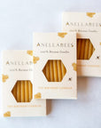 Hand-dipped beeswax birthday candles in a box of 10, natural and eco-friendly, made from pure honey beeswax; celebration theme, eco-friendliness, non-toxic nature, pure beeswax ingredients.