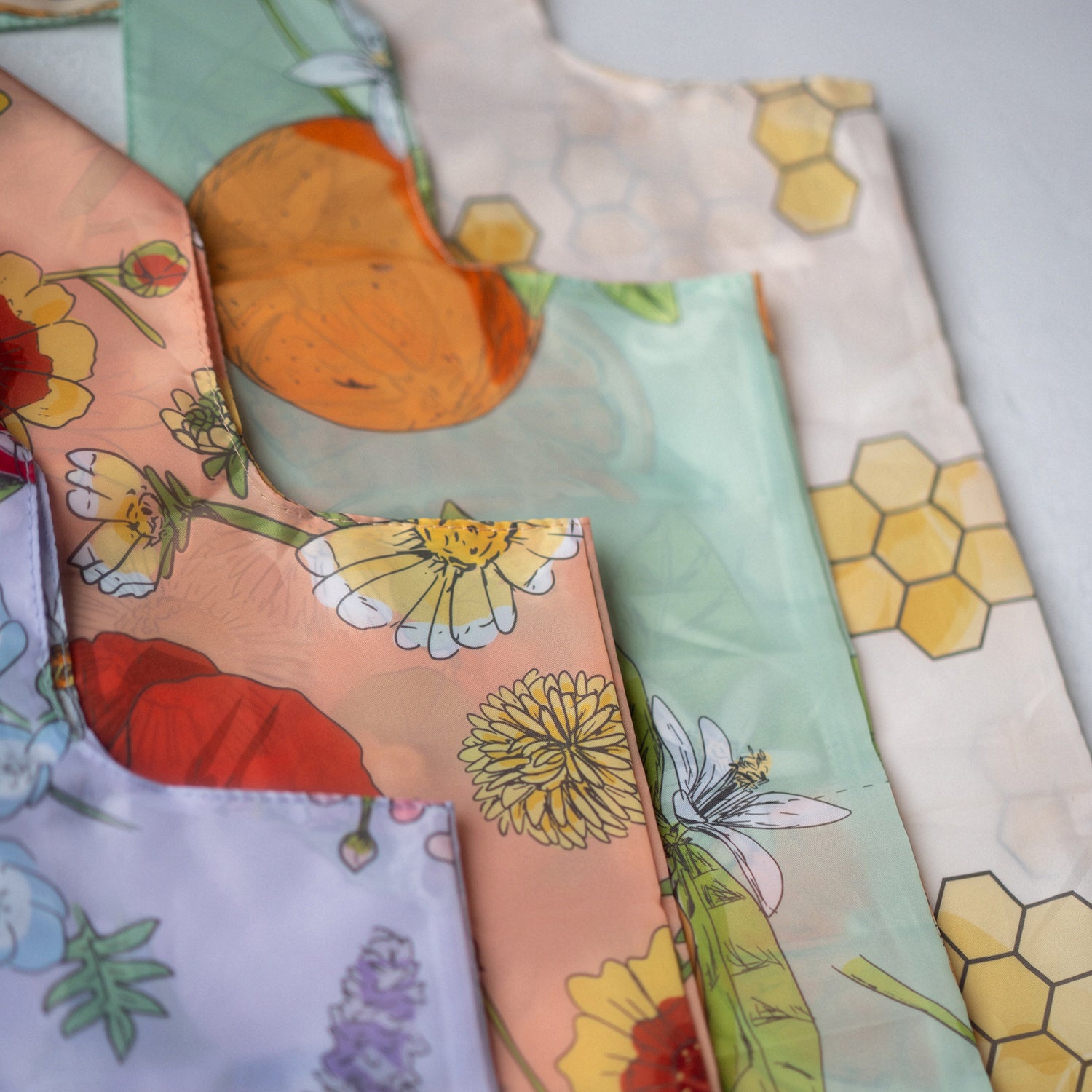 Reusable shopping tote bag with colorful flower patterns, eco-friendly, durable for shopping and farmers markets, sustainable, stylish, helps the planet, perfect for gifting.