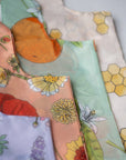Reusable shopping tote bag with colorful flower patterns, eco-friendly, durable for shopping and farmers markets, sustainable, stylish, helps the planet, perfect for gifting.